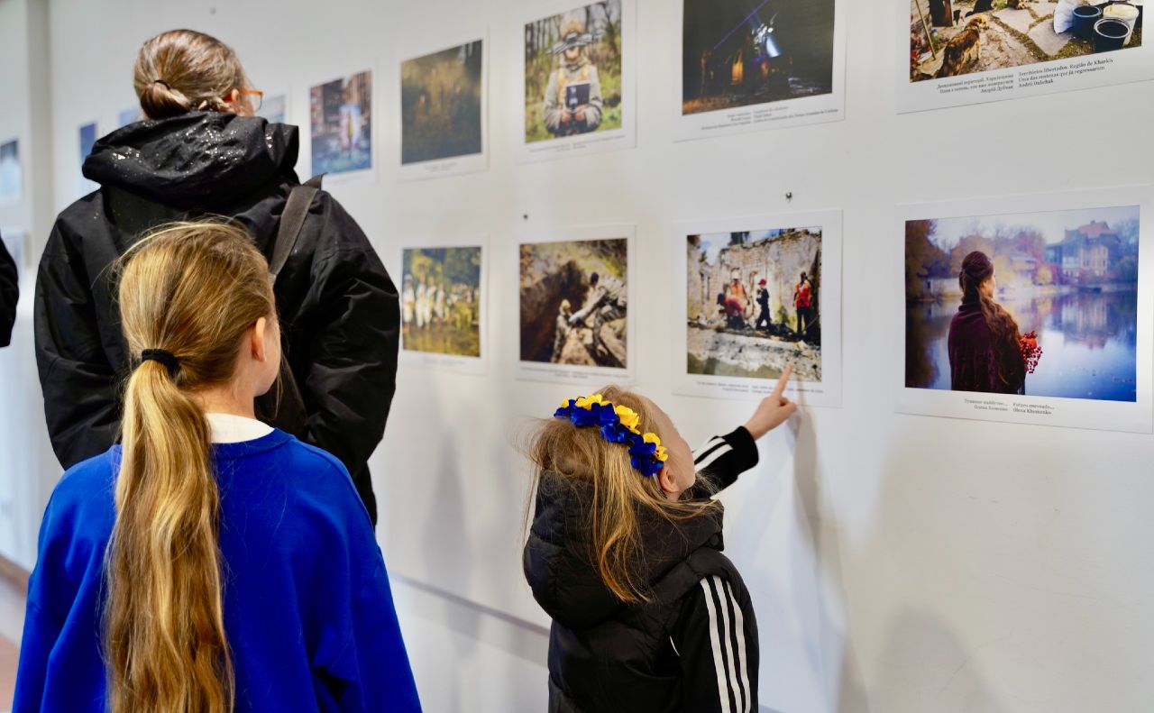 Дівчатка розглядають фотографії. Фото: Viktoriia Med
