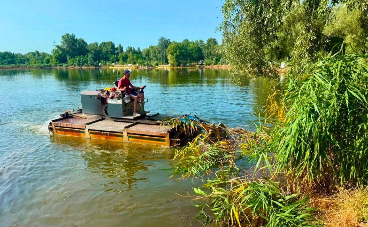 Біля водойми скошують рослинність та обробляють її сорбентом. Фото: КП «Плесо» у Фейсбук